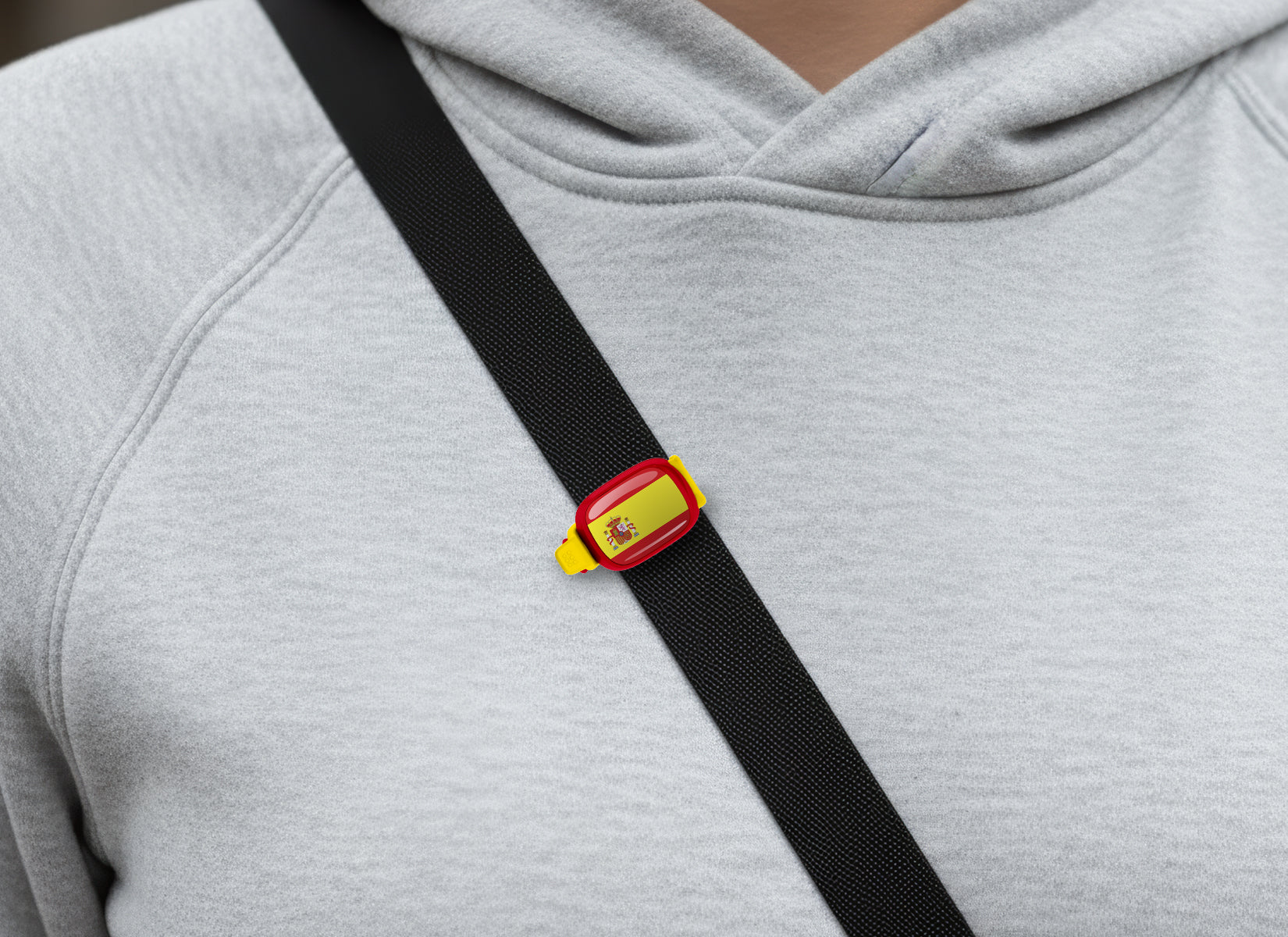 Spain flag Stwrap bag tag shown on a bag in a lifestyle setting
