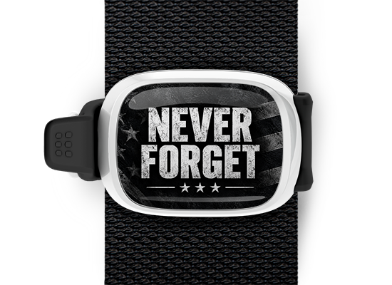 Never Forget 9/11 memorial Stwrap bag tag mounted on a black bag strap