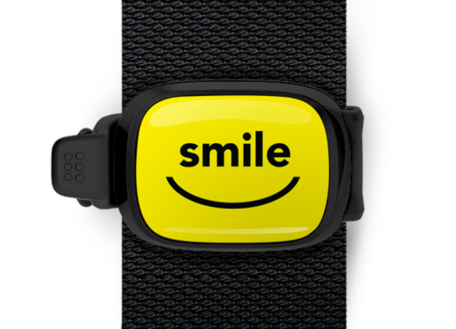 Smile Bag Tag mounted on a bag strap