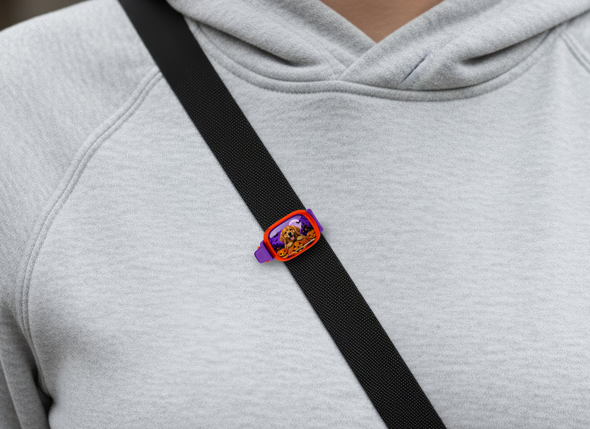 Halloween Golden Retriever Stwrap bag tag on a diagonal black strap over a gray sweatshirt