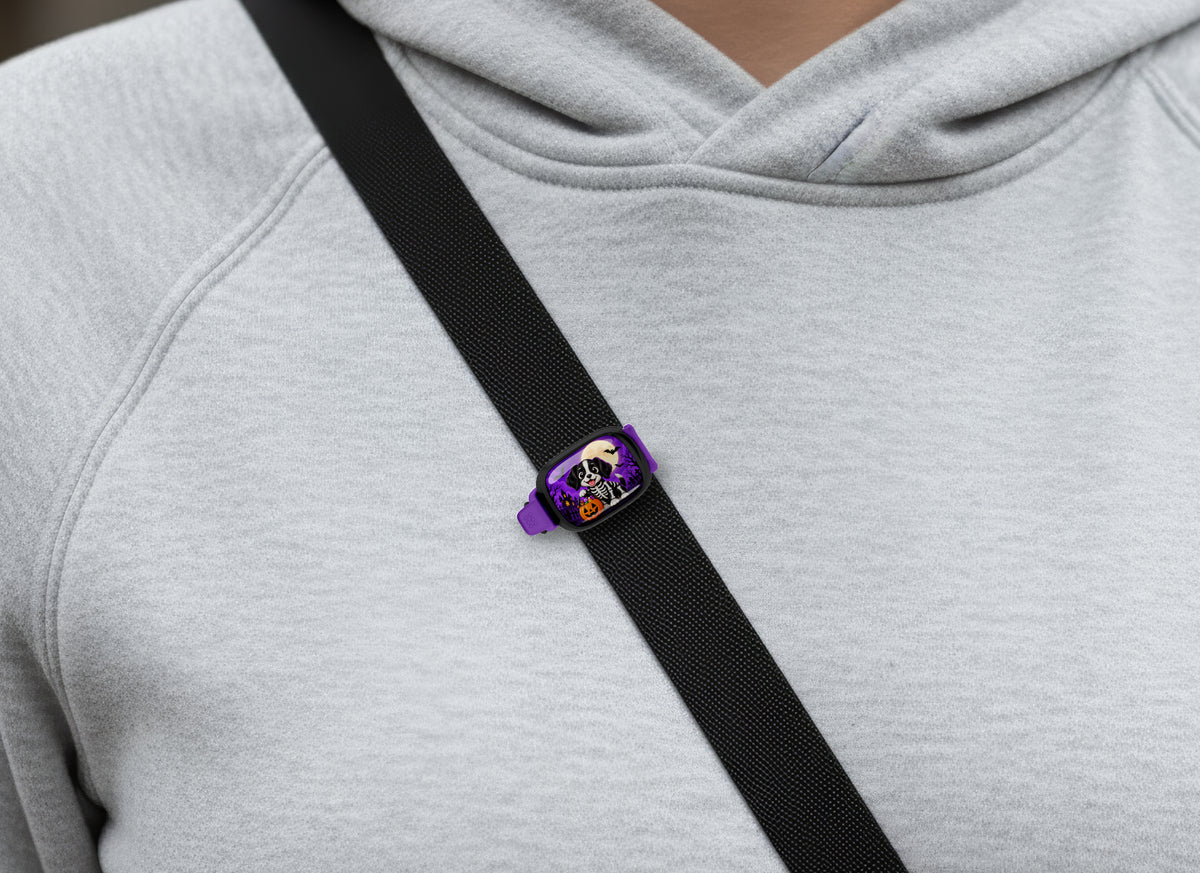 Skeleton Costume Dog Stwrap bag tag on a diagonal black strap over a gray sweatshirt