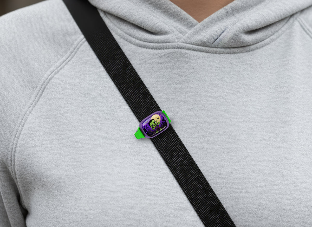 Cute Halloween Zombie Stwrap bag tag on a diagonal black strap over a gray sweatshirt