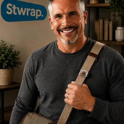 Tom Augustine, inventor and founder of Stwrap, wearing a Stwrap on a tan bag strap