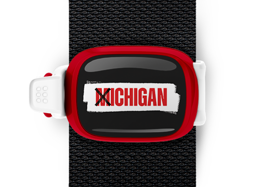 X Ichigan Bag Tag mounted on a bag strap